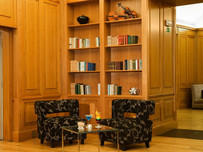 copyright @ Thalia Hotel; comfortable arm chairs and book shelves in the Bistro Restaurant